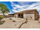Back exterior view shows desert landscaping, and patio with desert landscaping against a sunny sky at 17773 W Manso St, Goodyear, AZ 85338