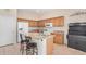 Bright kitchen featuring granite countertops, stainless steel appliances, and a charming breakfast bar at 17773 W Manso St, Goodyear, AZ 85338