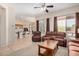 Open-concept living area with comfortable seating, a wooden coffee table, and seamless flow to the kitchen at 17773 W Manso St, Goodyear, AZ 85338
