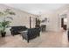 The spacious living room boasts stylish furniture and offers seamless access to the dining area at 17773 W Manso St, Goodyear, AZ 85338