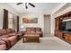 Inviting living room featuring plush seating, a wooden coffee table, and a built-in media center at 17773 W Manso St, Goodyear, AZ 85338