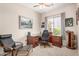 Inviting office with a wood desk, comfortable chair and a scenic view from the window at 17773 W Manso St, Goodyear, AZ 85338