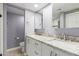 Bathroom featuring a double sink vanity with granite countertop and white cabinets at 18002 N 12Th St # 45, Phoenix, AZ 85022