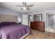 Comfortable bedroom with a tufted headboard, ceiling fan, and a dresser with a mirror at 18002 N 12Th St # 45, Phoenix, AZ 85022