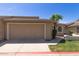 Home featuring a large two-car garage and desert landscaping, perfect for easy maintenance at 18002 N 12Th St # 45, Phoenix, AZ 85022