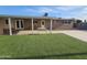 Backyard showcasing a covered patio, artificial grass, and plenty of space for outdoor activities at 1904 E Jarvis Ave, Mesa, AZ 85204