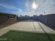 Expansive backyard with a patio, fenced perimeter, and green artificial turf, offering privacy and space at 1904 E Jarvis Ave, Mesa, AZ 85204
