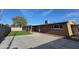 The backyard of the home with artificial grass and covered patio and driveway at 1904 E Jarvis Ave, Mesa, AZ 85204