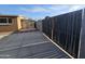 Backyard with concrete, brick trim, gate, and partial view of the house with a window at 1904 E Jarvis Ave, Mesa, AZ 85204