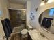 Well-lit bathroom features a modern vanity, toilet, and tiled shower with glass door at 1904 E Jarvis Ave, Mesa, AZ 85204