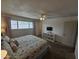 This bedroom has a queen bed, a window with curtains, and a white shelving unit at 1904 E Jarvis Ave, Mesa, AZ 85204