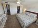 Comfortable bedroom with floral bedding, ceiling fan, and a closet, offering a relaxing retreat at 1904 E Jarvis Ave, Mesa, AZ 85204