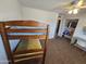 This carpeted bedroom features a wooden bunkbed, fan, and a closet with clothing at 1904 E Jarvis Ave, Mesa, AZ 85204