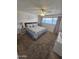 This bedroom boasts a floral-patterned bedspread, soft carpet, and a ceiling fan for added comfort at 1904 E Jarvis Ave, Mesa, AZ 85204