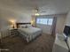 Bright bedroom featuring carpet flooring, large windows, side tables, and a ceiling fan at 1904 E Jarvis Ave, Mesa, AZ 85204
