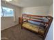 Comfortable bedroom featuring a bunk bed, carpet, and a well-lit window at 1904 E Jarvis Ave, Mesa, AZ 85204