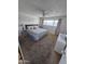 Cozy bedroom with floral bedding, ceiling fan, and natural light from the window at 1904 E Jarvis Ave, Mesa, AZ 85204