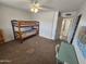 Bedroom with bunkbeds, carpet flooring, and a desk, offering a functional space at 1904 E Jarvis Ave, Mesa, AZ 85204