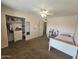 Cozy bedroom featuring a bed, a closet, and white shelving and drawer unit at 1904 E Jarvis Ave, Mesa, AZ 85204