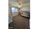 A tidy bedroom features a bunk bed, a ceiling fan, and a natural light from the window at 1904 E Jarvis Ave, Mesa, AZ 85204