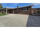 A concrete backyard and exterior of home with brown brick finishings at 1904 E Jarvis Ave, Mesa, AZ 85204