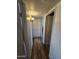 Hallway features plank flooring, overhead lighting, and storage cabinets for functionality at 1904 E Jarvis Ave, Mesa, AZ 85204