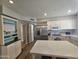 Open kitchen featuring white cabinets, stainless steel appliances, and a center island with stone countertop at 1904 E Jarvis Ave, Mesa, AZ 85204