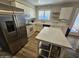 Bright updated kitchen features stainless steel appliances, countertops, and an island at 1904 E Jarvis Ave, Mesa, AZ 85204