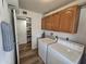 Functional laundry room with washer, dryer, and storage cabinets, ensuring efficient organization at 1904 E Jarvis Ave, Mesa, AZ 85204
