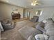 Cozy living room with plush seating, a charming piano, and a neutral color palette at 1904 E Jarvis Ave, Mesa, AZ 85204