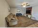 Living Room with comfortable sofa, armchairs, a ceiling fan, and modern entertainment center at 1904 E Jarvis Ave, Mesa, AZ 85204