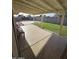 Covered patio with a swing, bench seating, and artificial turf in backyard at 1904 E Jarvis Ave, Mesa, AZ 85204