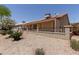 Backyard featuring a covered patio, well-maintained desert landscaping and an attractive wrought iron fence at 1917 E Lindrick Dr, Chandler, AZ 85249