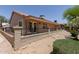 Exterior view of the backyard featuring covered patio, desert landscaping and decorative fence at 1917 E Lindrick Dr, Chandler, AZ 85249