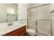 Bathroom featuring a toilet, frosted glass shower, and sink with wood vanity at 1917 E Lindrick Dr, Chandler, AZ 85249