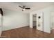 Spacious bedroom featuring hardwood floors, a ceiling fan, and a walk in closet at 1917 E Lindrick Dr, Chandler, AZ 85249