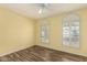 Bright bedroom with hardwood floors, ceiling fan, and arched windows offering natural light at 1917 E Lindrick Dr, Chandler, AZ 85249