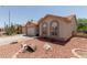 Charming single-story home with desert landscaping, barrel decor, and covered entryway at 1917 E Lindrick Dr, Chandler, AZ 85249