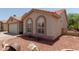 Charming single-story home with desert landscaping, barrel decor, and covered entryway at 1917 E Lindrick Dr, Chandler, AZ 85249