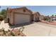 Charming single-story home with desert landscaping and a large two car garage at 1917 E Lindrick Dr, Chandler, AZ 85249