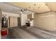 Spacious garage interior with storage cabinets, water heater, and ample room for parking and projects at 1917 E Lindrick Dr, Chandler, AZ 85249