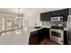 Modern kitchen featuring stainless steel appliances, dark cabinets, and a bright countertop overlooking the living area at 1917 E Lindrick Dr, Chandler, AZ 85249