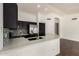 Modern kitchen featuring stainless steel appliances, dark cabinets, and a bright countertop with stylish backsplash at 1917 E Lindrick Dr, Chandler, AZ 85249