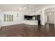 Open-concept living room with dark wood floors, white walls, and view of kitchen at 1917 E Lindrick Dr, Chandler, AZ 85249