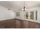 Bright living room featuring wood floors, ceiling fan, and sliding doors to a private balcony or patio at 1917 E Lindrick Dr, Chandler, AZ 85249