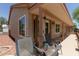 Relaxing covered patio area with comfortable seating, tile roof and desert landscaping at 1917 E Lindrick Dr, Chandler, AZ 85249