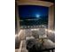 Charming balcony with mountain view, adorned with patio chairs, a table, and decorative string lights at 19550 N Grayhawk Dr # 2023, Scottsdale, AZ 85255