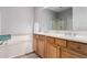 Spacious bathroom boasts double sinks, a soaking tub, and separate shower for a luxurious experience at 19550 N Grayhawk Dr # 2023, Scottsdale, AZ 85255
