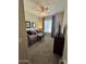 Cozy bedroom with a ceiling fan, window with drapes, and comfortable furnishings at 19550 N Grayhawk Dr # 2023, Scottsdale, AZ 85255