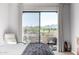 Bright bedroom with balcony access, offering stunning desert landscape views and an inviting atmosphere at 19550 N Grayhawk Dr # 2023, Scottsdale, AZ 85255